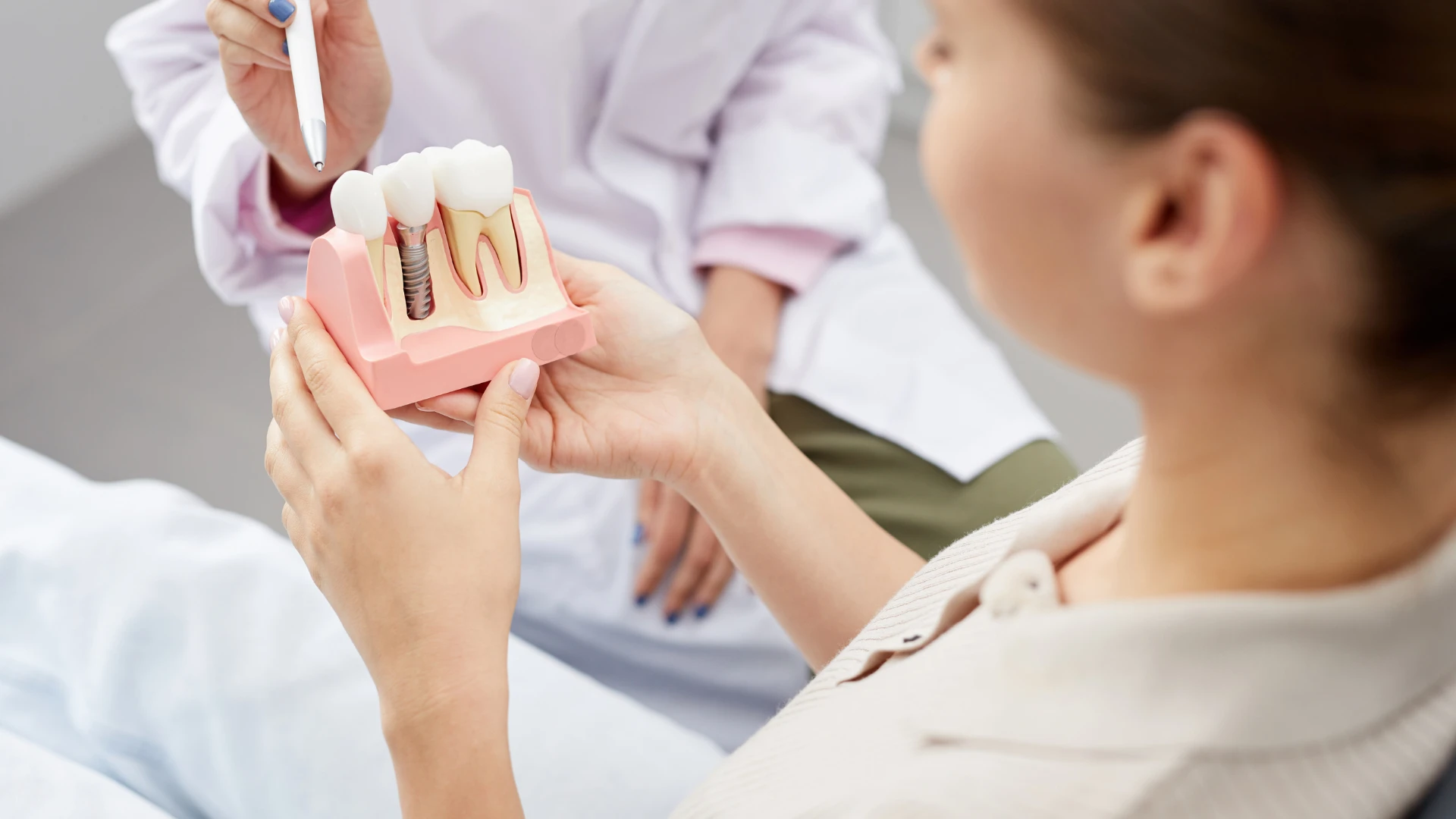 Dentist placing a dental implant during surgical procedure